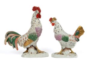 A pair of Continental pottery figures of a cockerel and a chicken