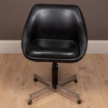 A mid-century black vinyl swivel pod chair in the manner of Overman