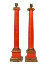 A pair of red painted table lamps