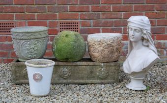 A collection of planters and a garden ornament