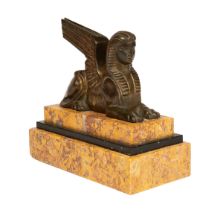 A bronze statuette of a winged sphinx