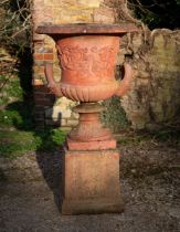 A terracotta coloured cast reconstituted stone campana urn