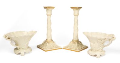 A pair of Royal Worcester libation cups and a pair of candle sticks