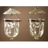 A pair of modern etched glass ceiling lights