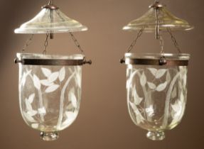 A pair of modern etched glass ceiling lights
