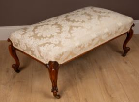 A mahogany framed footstool with silk upholstery