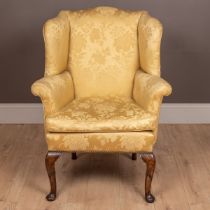 An antique Georgian style small wingback armchair