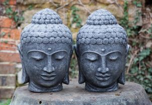 A pair of cast reconstituted stone Buddha heads