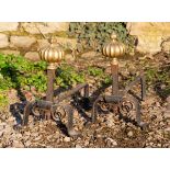A pair of antique brass and wrought iron fire dogs