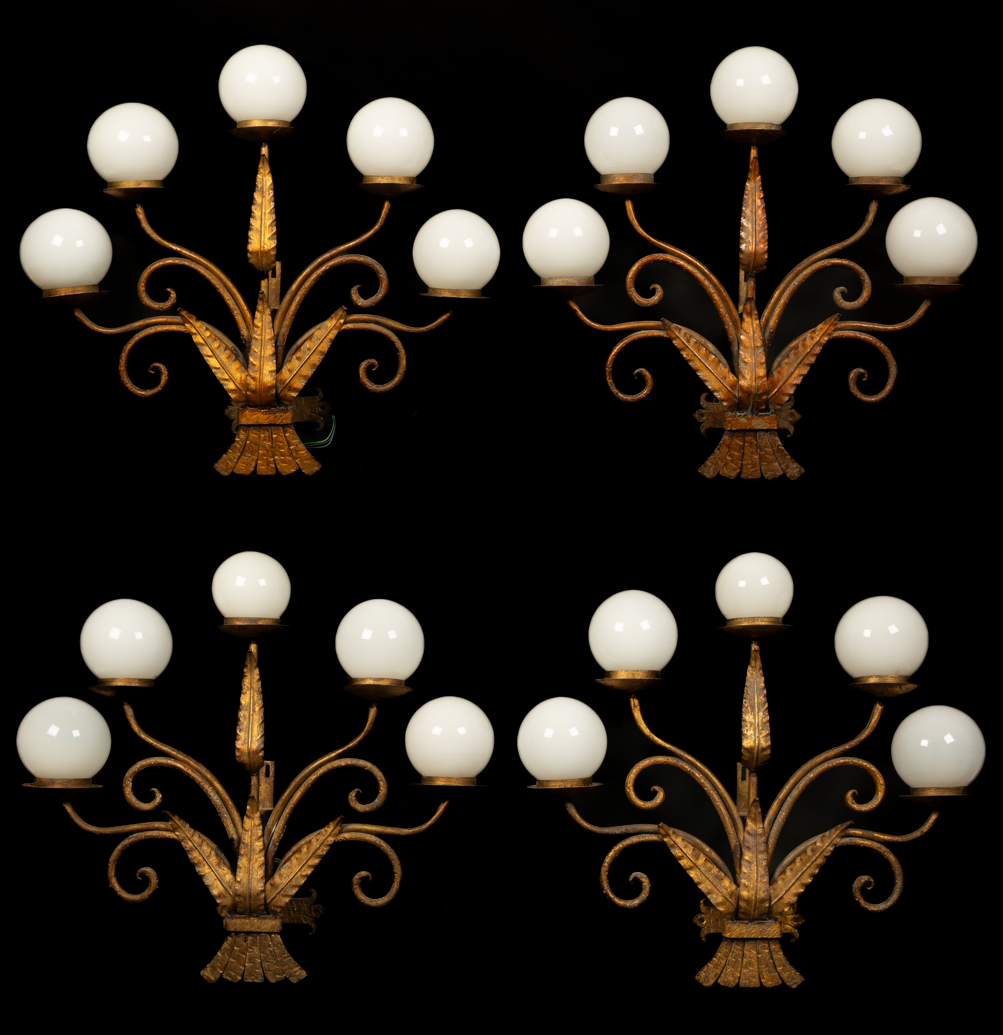 A set of four five-branch gilt metal wall lights