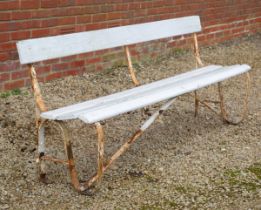 A white-painted iron framed garden bench