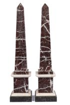 A pair of red marble obelisks