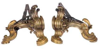 A pair of antique Rococo style cast brass chenets