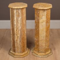 A pair of travertine plinths
