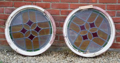A pair of early 20th century circular leaded coloured glass windows