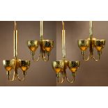 A set of four Kalmar three-branch brass chandeliers