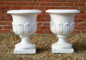 A pair of white-painted reconstituted stone garden urns