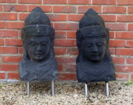 A pair of cast reconstituted stone heads in the Oriental style
