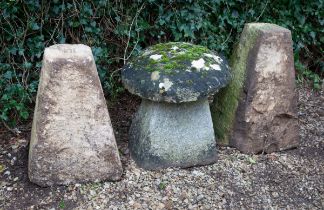 A small staddle stone together with two staddle stone bases