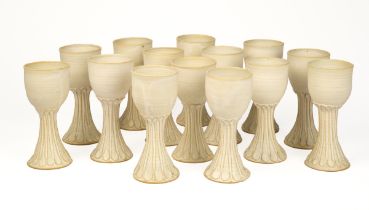 A set of fourteen pottery wine goblets