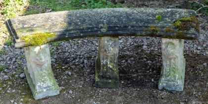 A cast reconstituted stone curving garden bench