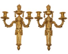 A pair of antique ormolu two-branch wall lights in the Continental Neoclassical style