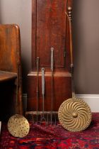 Three antique toasting forks, a bedpan, and a skimmer