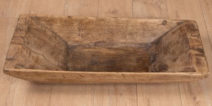 A rustic carved wooden trug