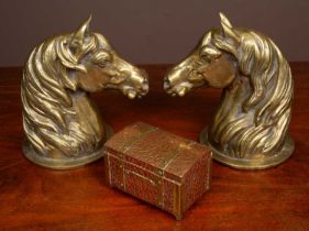 A pair of heavy brass horse head door stops together with a copper tea caddy