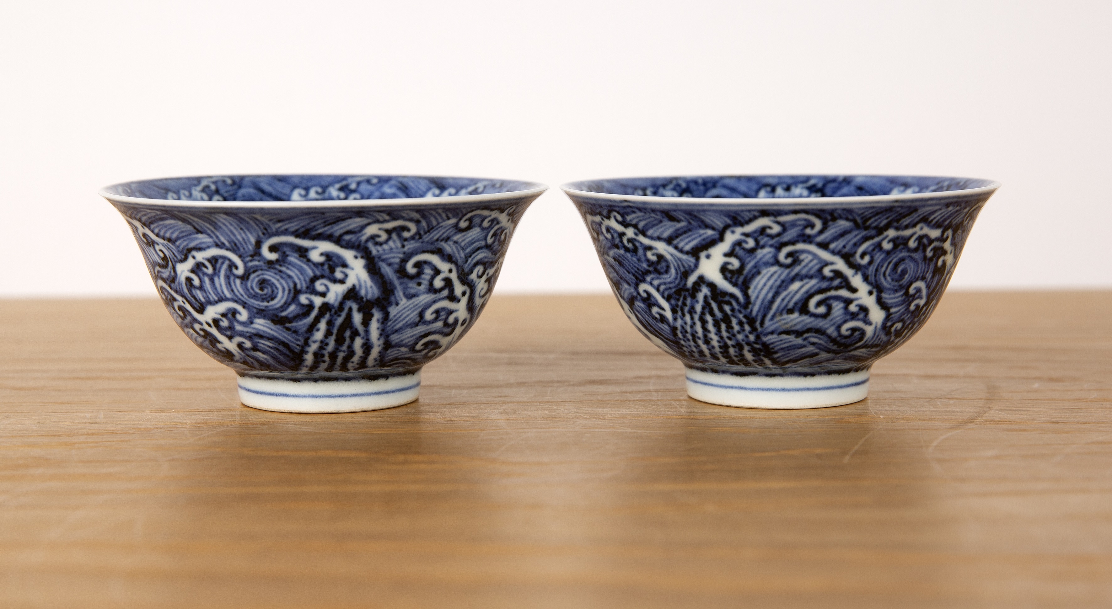Pair of blue wave pattern bowls Chinese, 19th Century each on a raised foot with a single band, 10cm