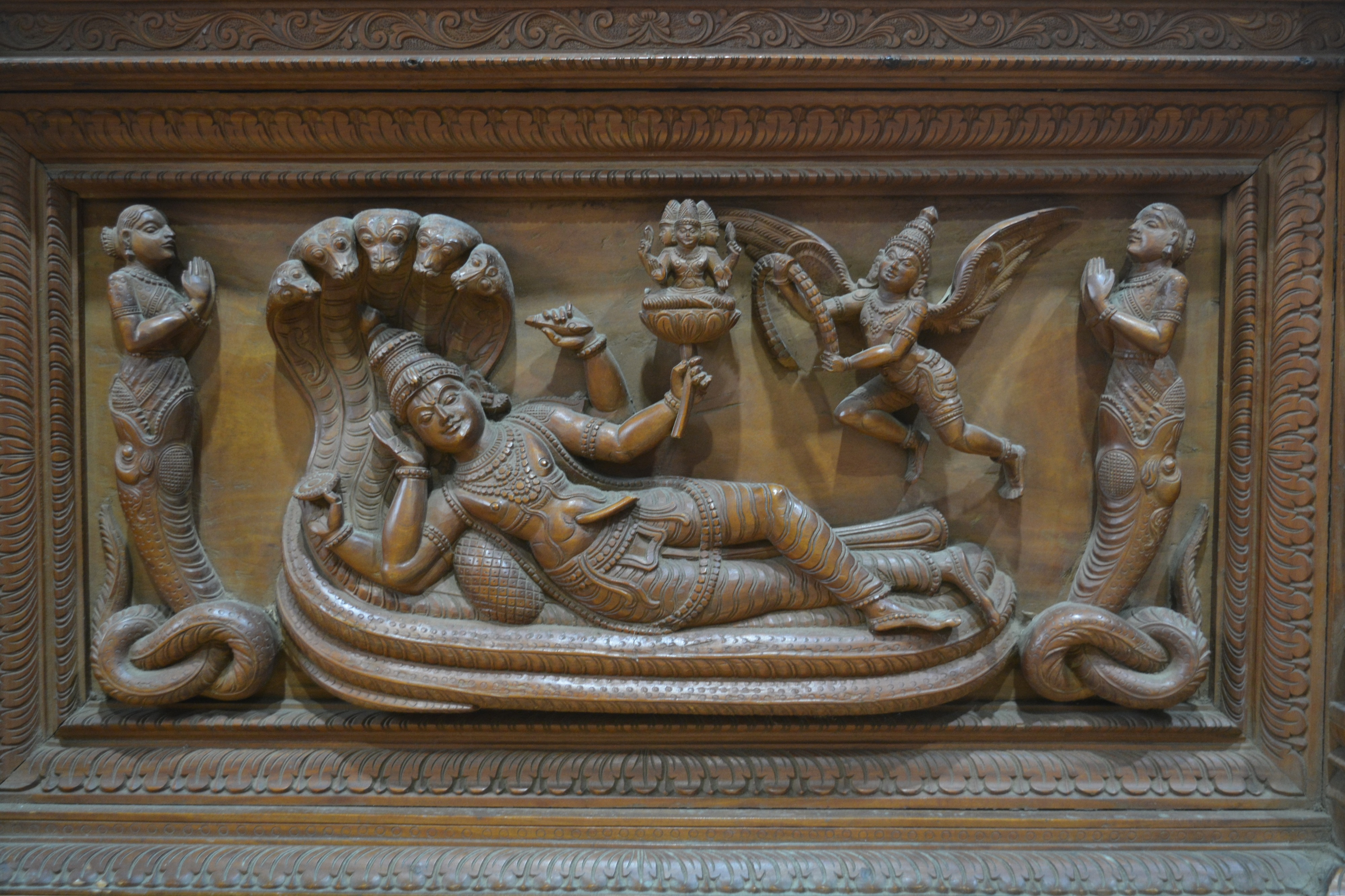 Hardwood arched panel Indian carved with a recumbent Shiva and further acolytes, 60cm x 84cm overall - Image 2 of 3