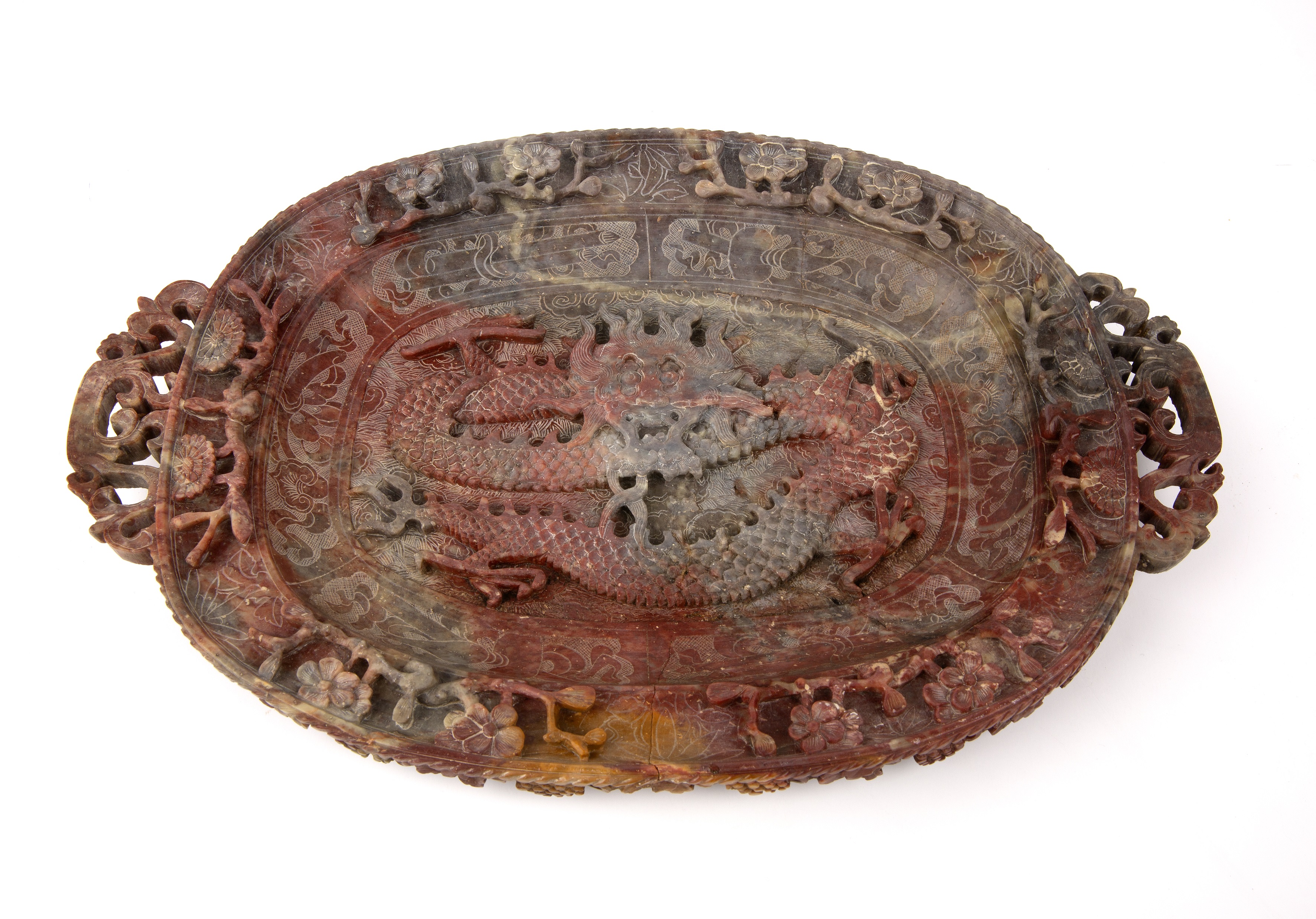 Carved soapstone oval dish Chinese the centre carved in relief with a scaled dragon in flight, the
