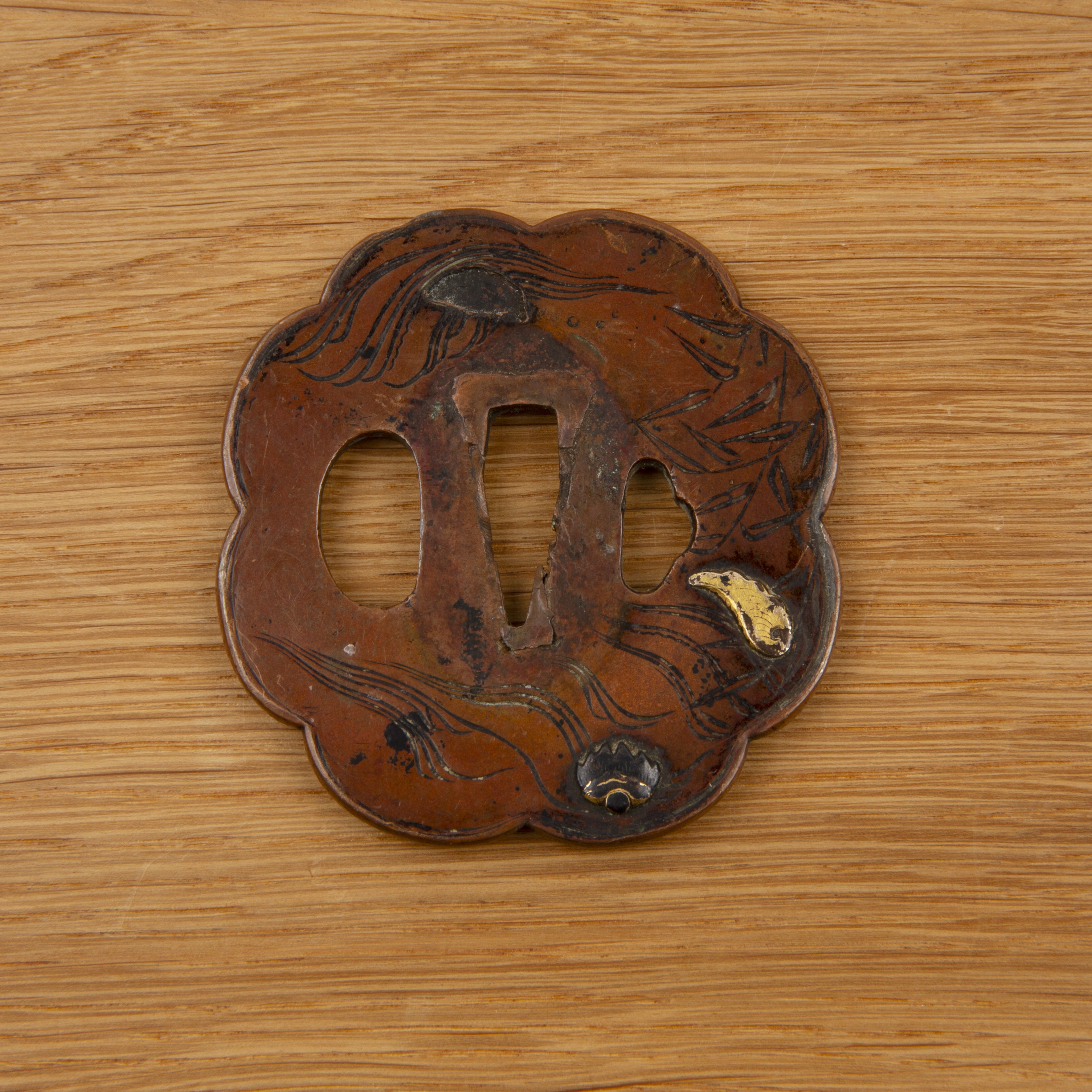 Dark copper tsuba Japanese, Edo period of eight lobed circular form, decorated in iro-e-zogan with