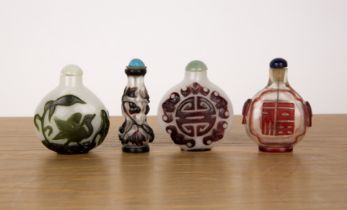 Four Peking glass snuff bottles Chinese including an opaque bottle with birds, a white opaque bottle