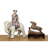Porcelain model of an elephant and a girl Chinese, mid-20th Century the seated figure holding a
