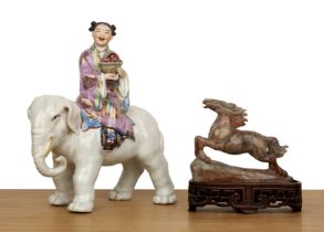 Porcelain model of an elephant and a girl Chinese, mid-20th Century the seated figure holding a