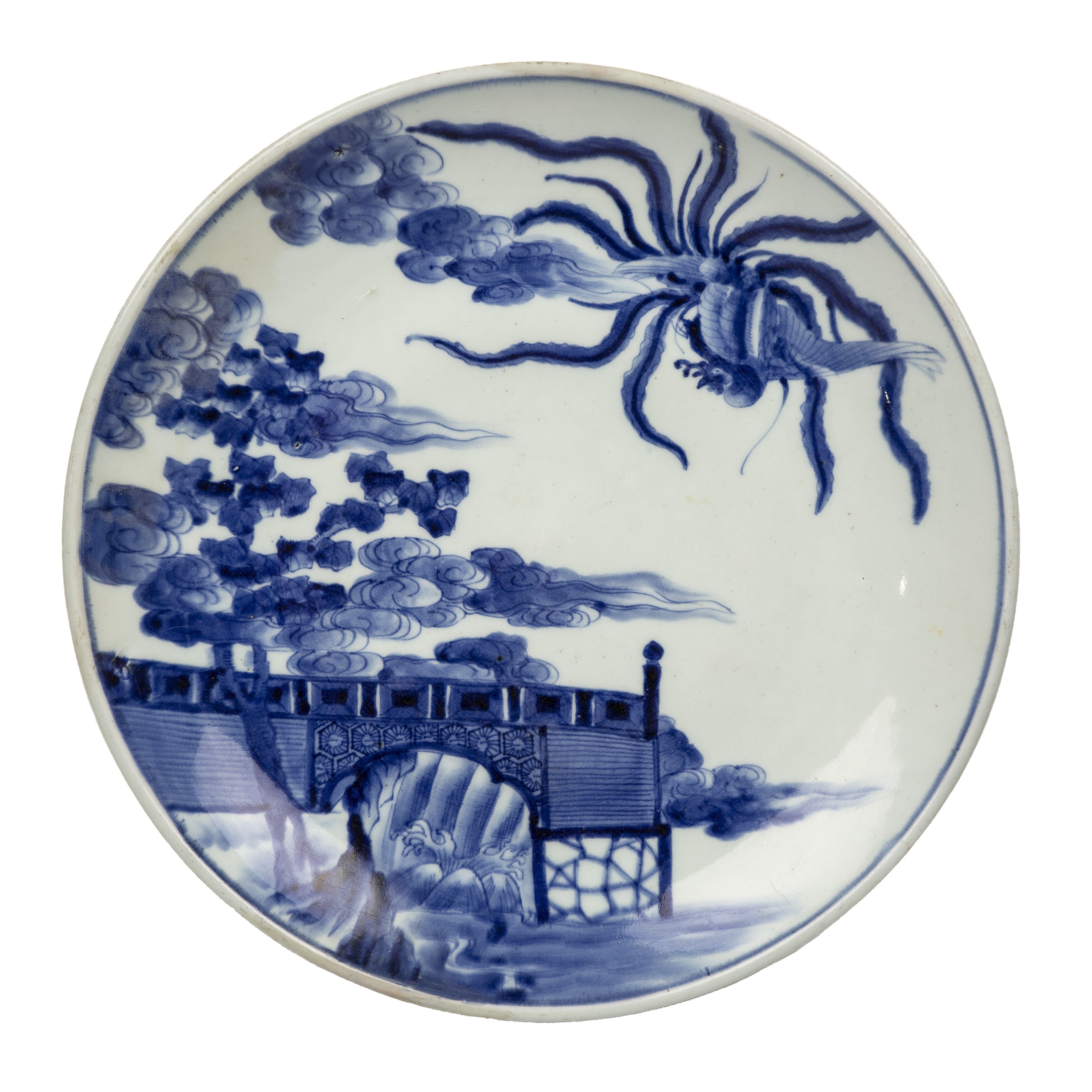 Blue and white porcelain charger Japanese, 19th Century painted with a phoenix above a pine tree,