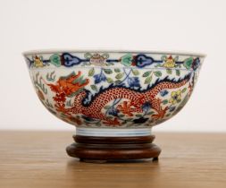 Wucai porcelain bowl Chinese painted in polychrome enamels with a central dragon and flaming pearls.