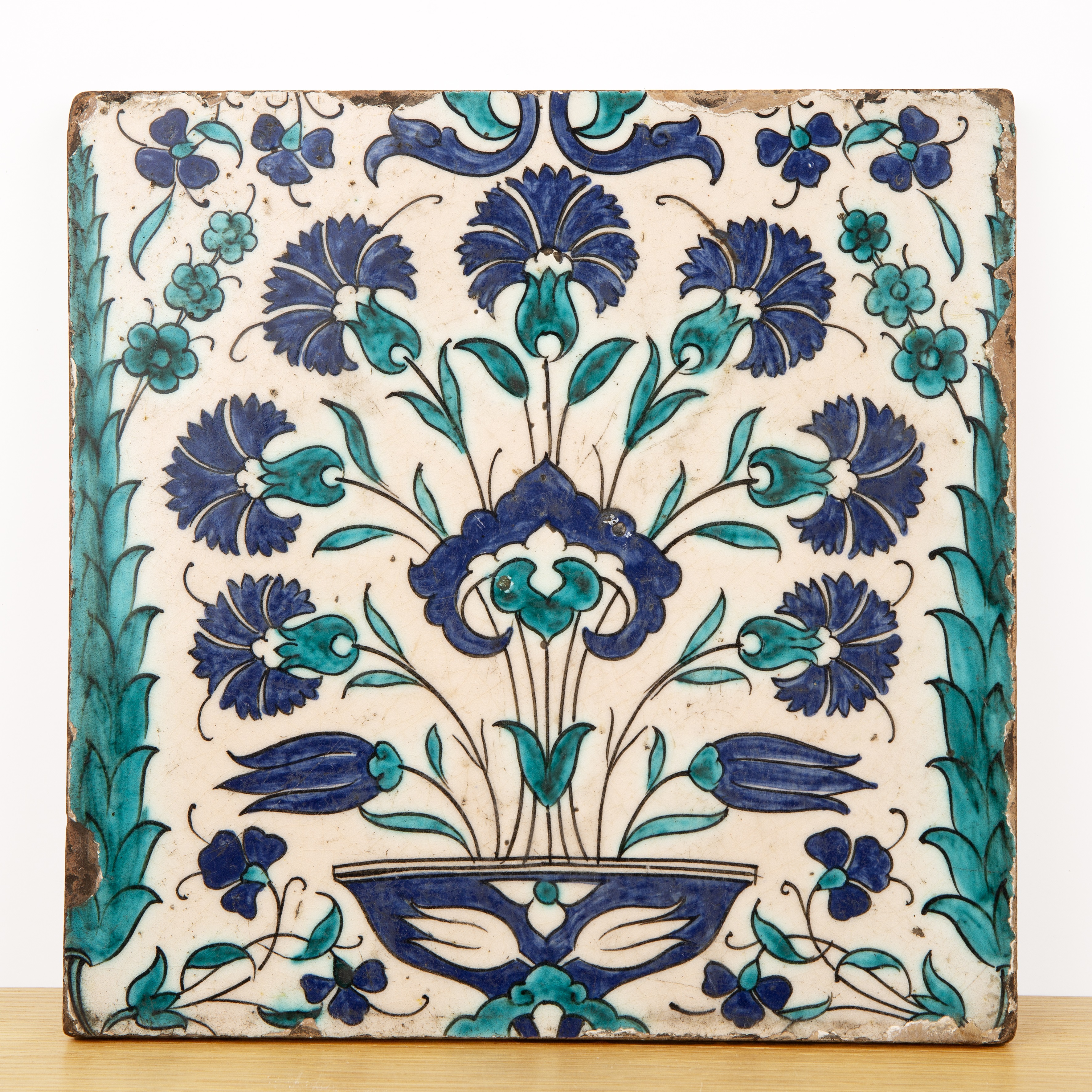 Iznik style Cantagalli tile Turkish painted in the 16th Century style with a vase of tulips, in a