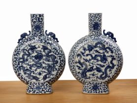 Pair of large blue and white porcelain moon flasks Chinese, 19th Century each painted with dragons