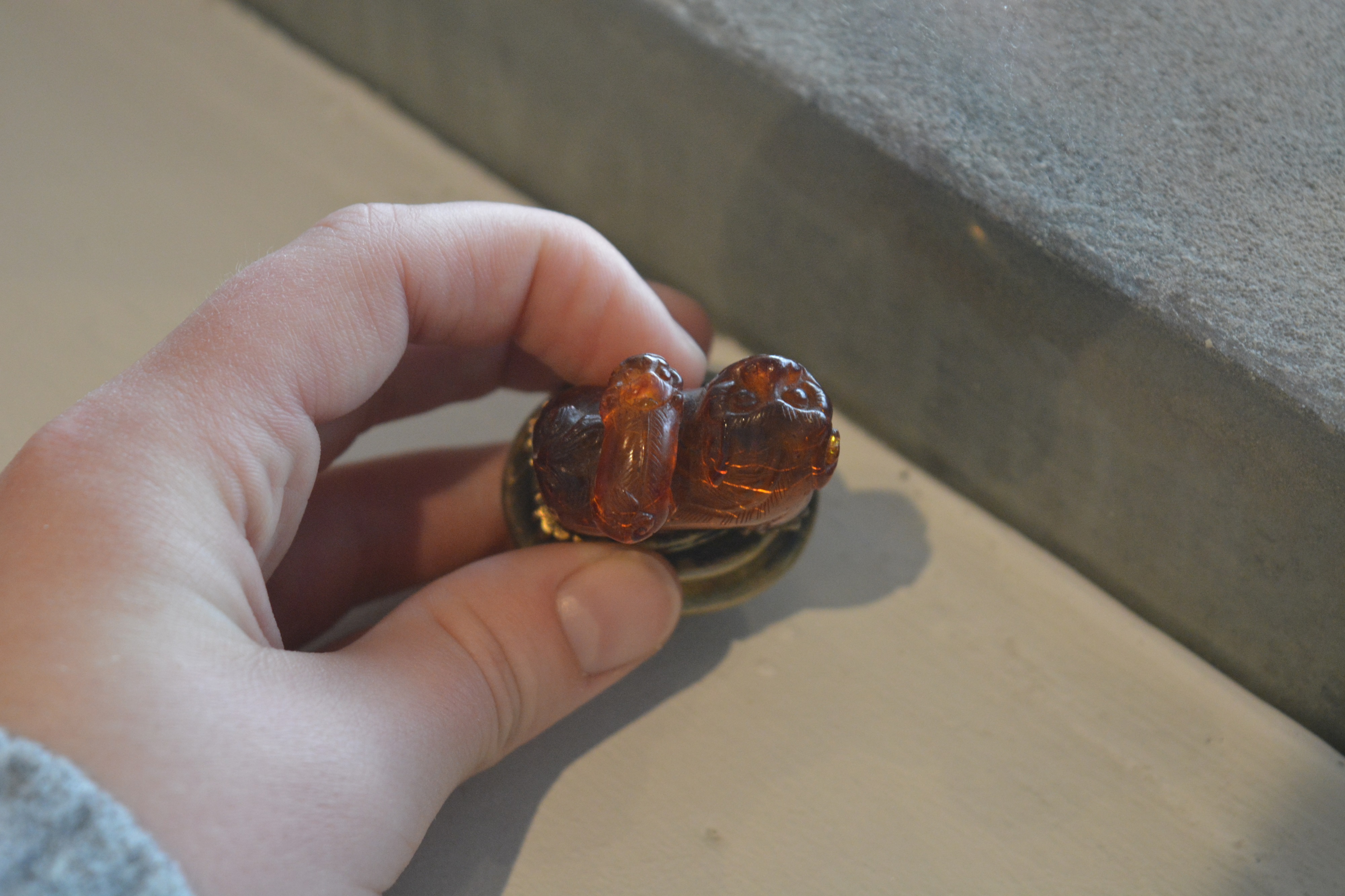 Amber kylin seal Chinese, 19th Century mounted on a metal and glass oval base, with a puppy on its - Image 13 of 13