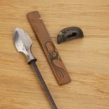 Three iron pieces Japanese including a shakudo toggle, 3cm long, an iron arrow with an inscribed