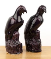 Pair of aubergine model falcons Chinese, 19th Century each with their mouths open and perched on