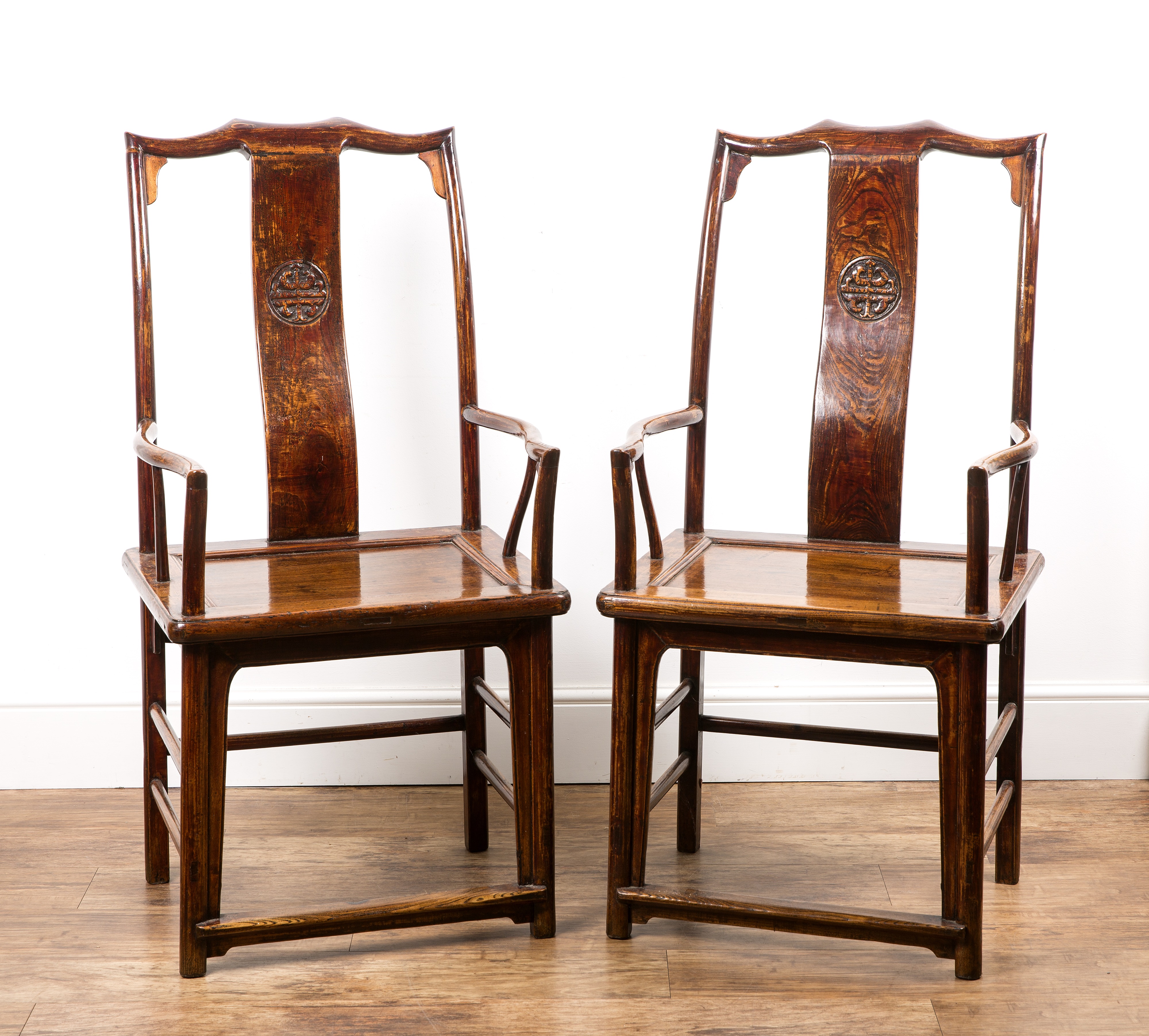 Pair of elm Ming-style armchairs Chinese each with a carved back rail and solid seat, 116cm high x