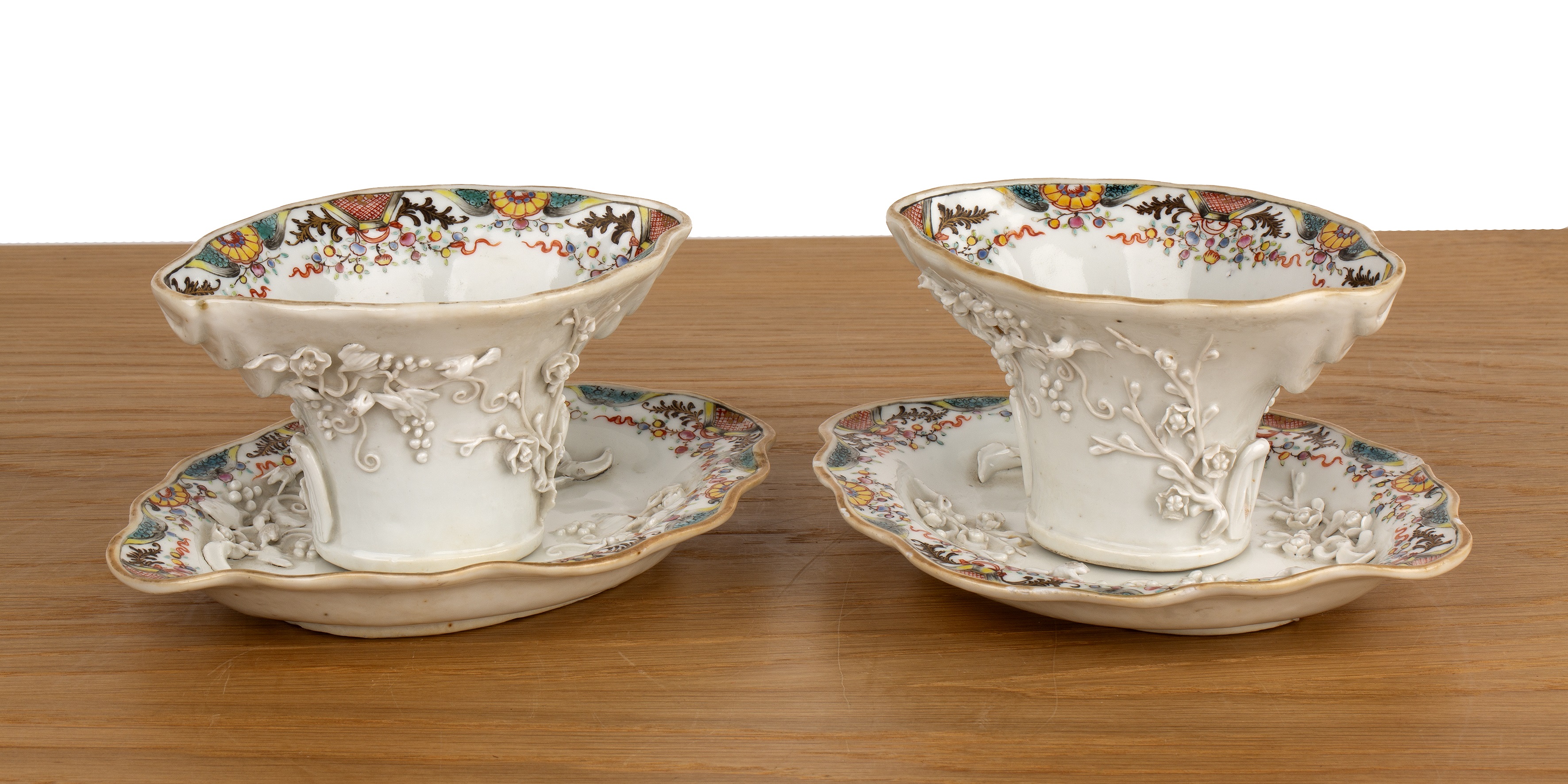 Pair of export porcelain libation cups and stands Chinese, 18th Century of white ground with