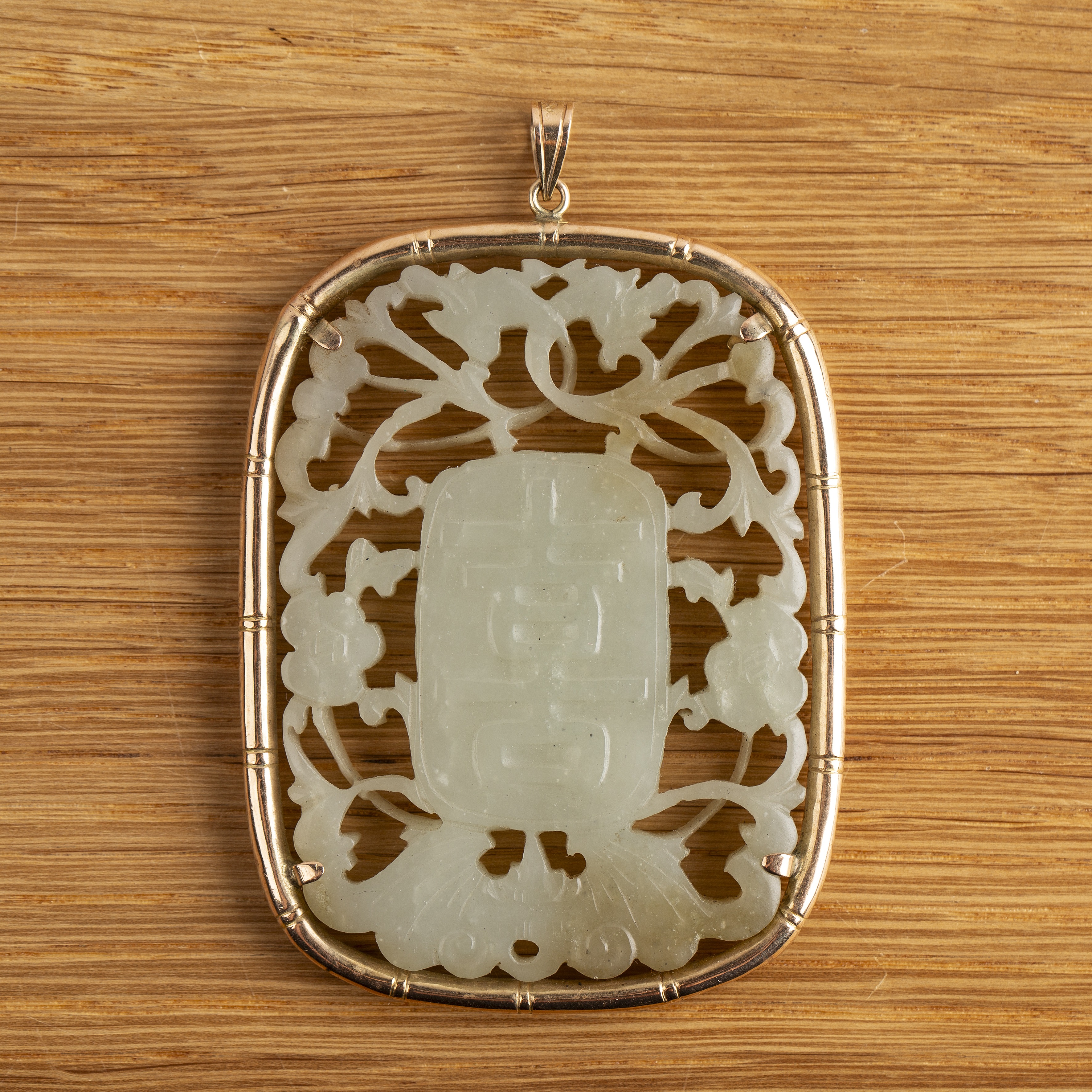Oval jade carved pendant Chinese, 19th Century with a central panel to each side with a Shou