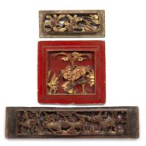 Three carved wood gilt temple carvings Chinese the first painted garnet red and decorated with a