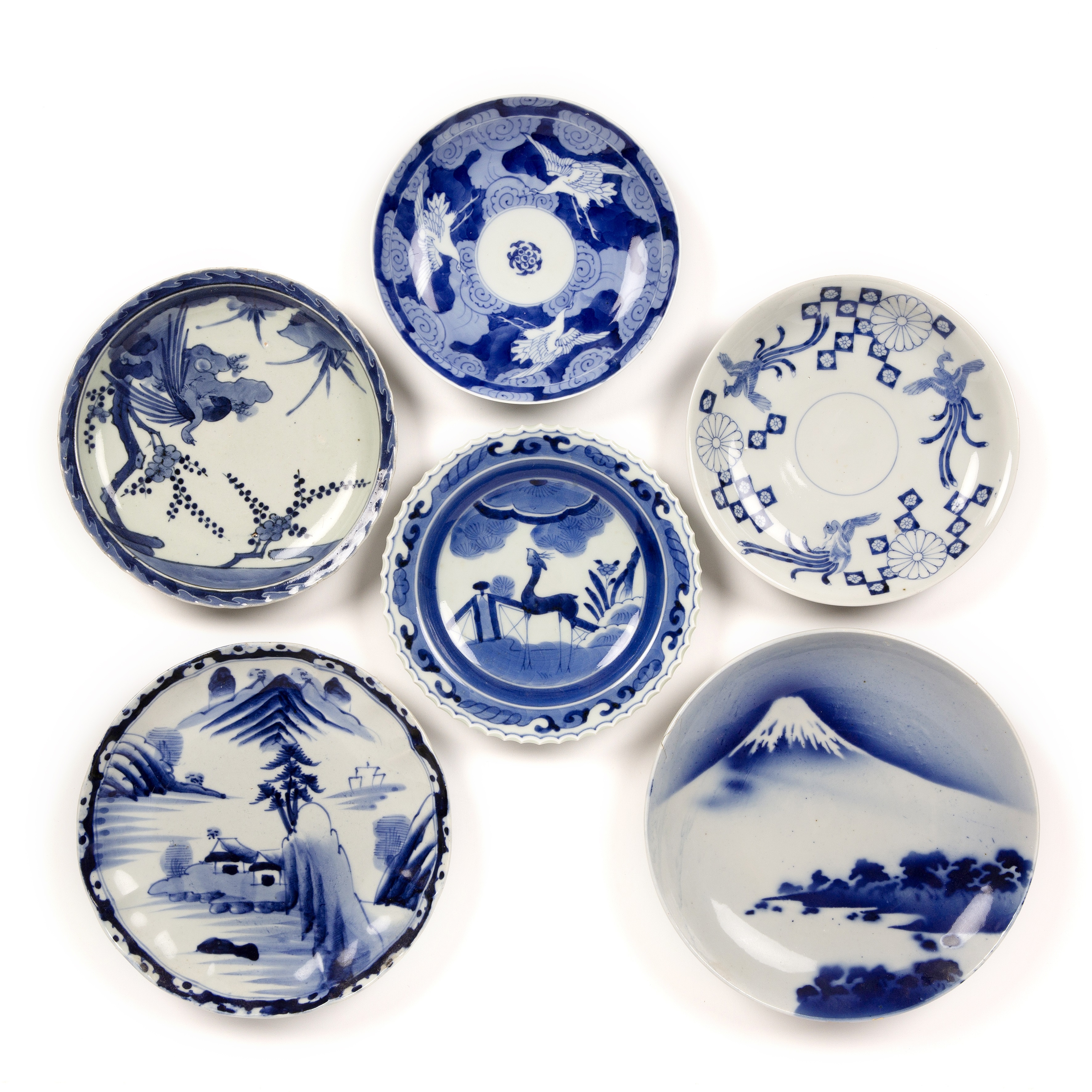 Group of Arita blue and white dishes Japanese, 19th Century variously decorated with phoenix, deer
