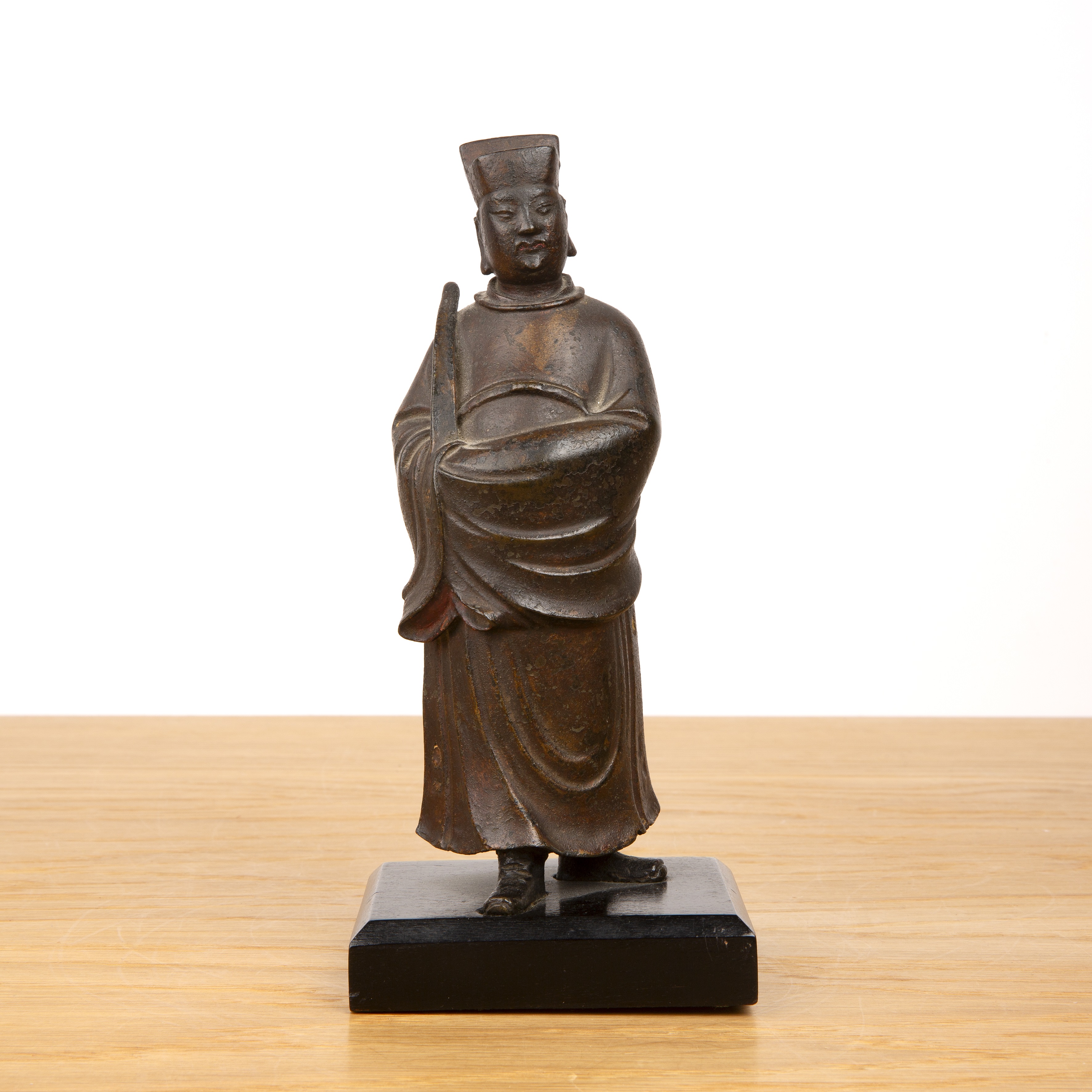 Bronze composite-filled standing guardian figure on a wood stand Chinese, late Ming the standing