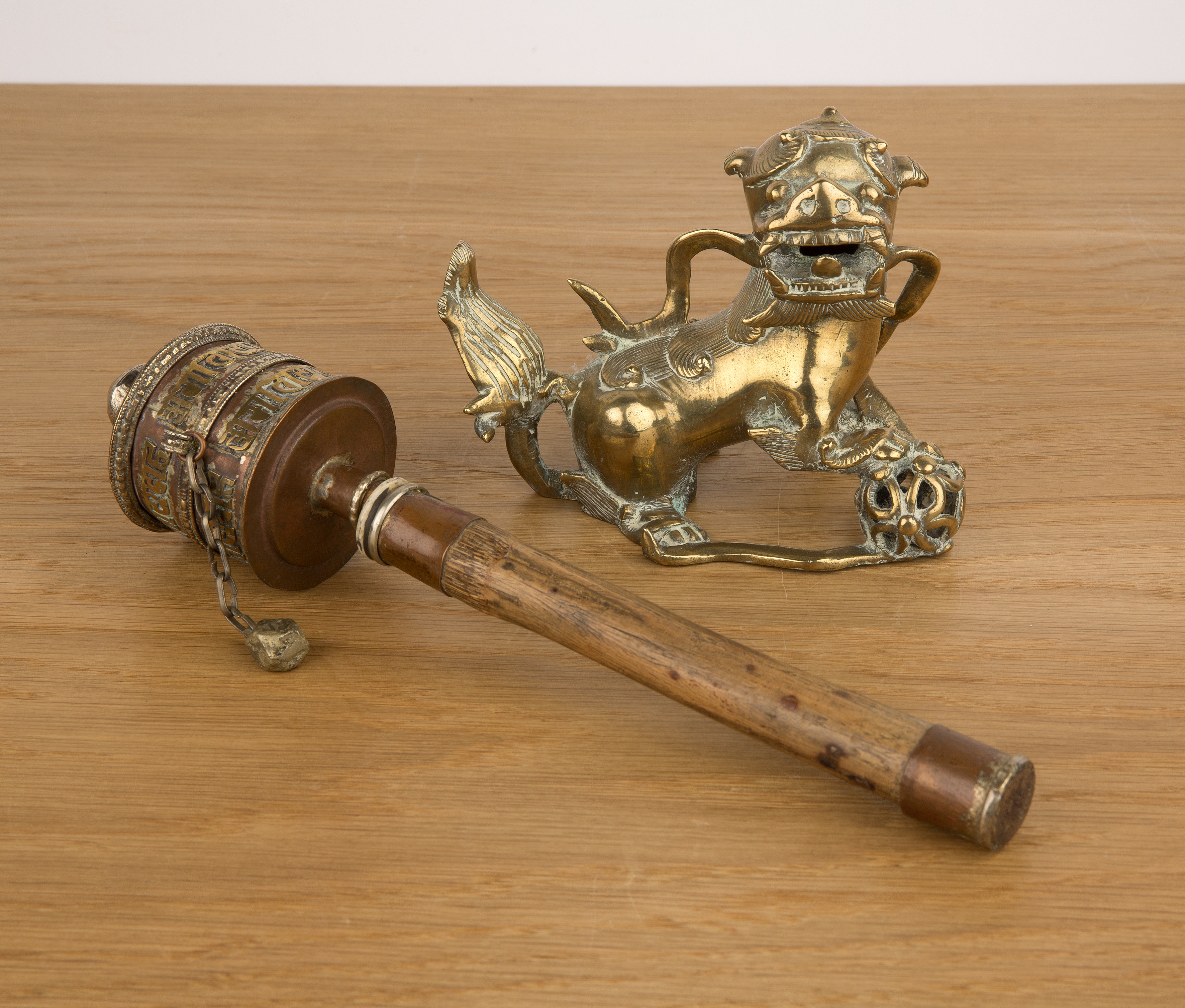 Prayer wheel and a brass temple dog Tibetan and Chinese the wheel with a bamboo handle, 29cm and